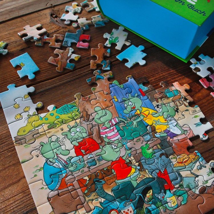 Produktbild: Die Olchis. Puzzle im Buch. 100 Teile